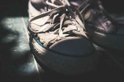 A pair of white sneakers to tie his shoes
